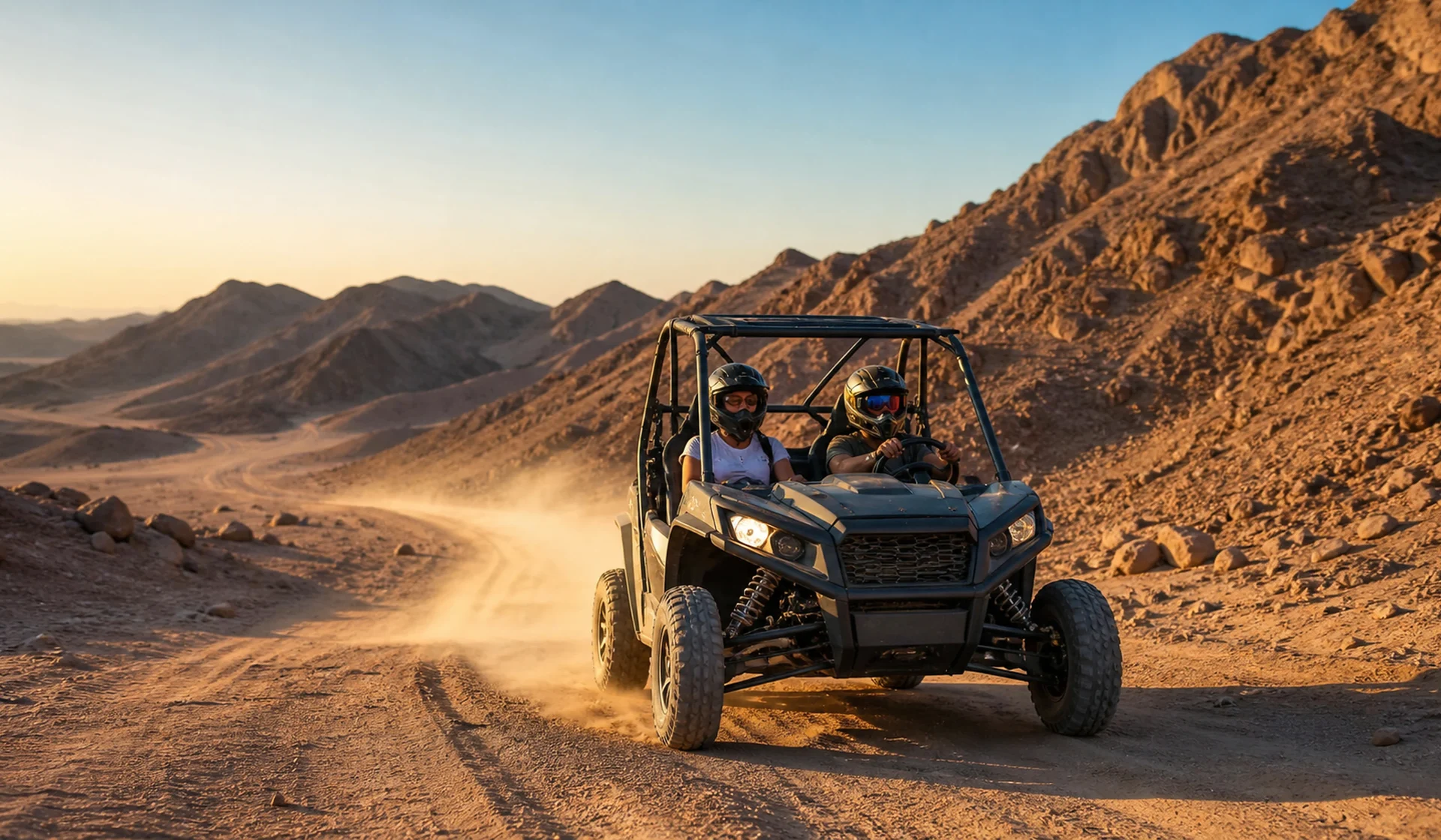 Two travelers riding a side-by-side buggy through the Eastern Desert mountains
