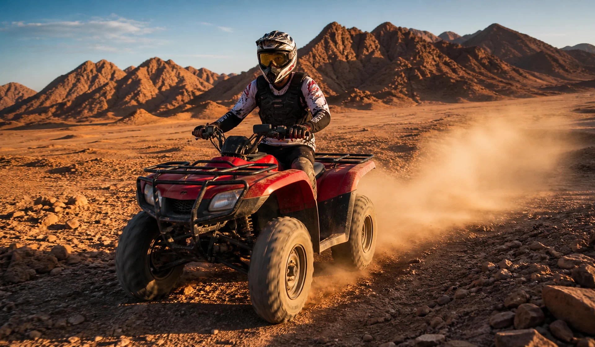 Helmeted rider on a quad bike crossing the Eastern Desert near Marsa Alam
