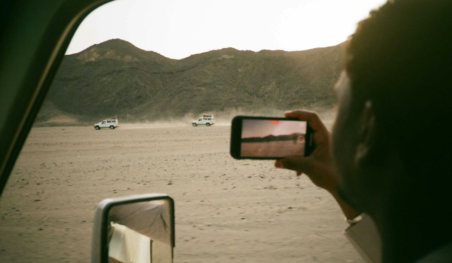 Four-wheel-drive vehicles crossing the Eastern Desert mountains