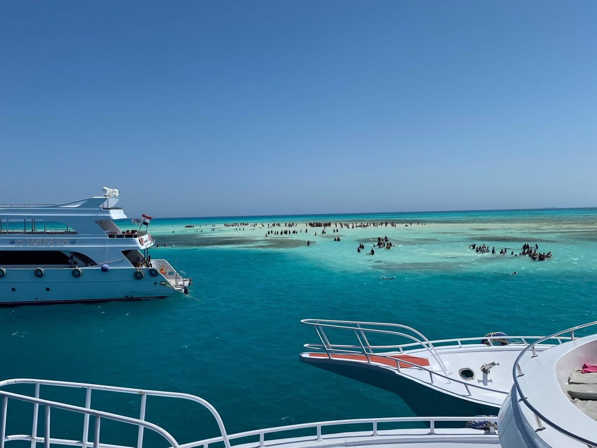 Excursion boats moored beside a bright Red Sea sandbank