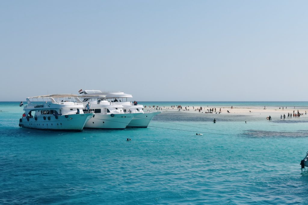 Boat beside a clear turquoise sandbank in the southern Red Sea