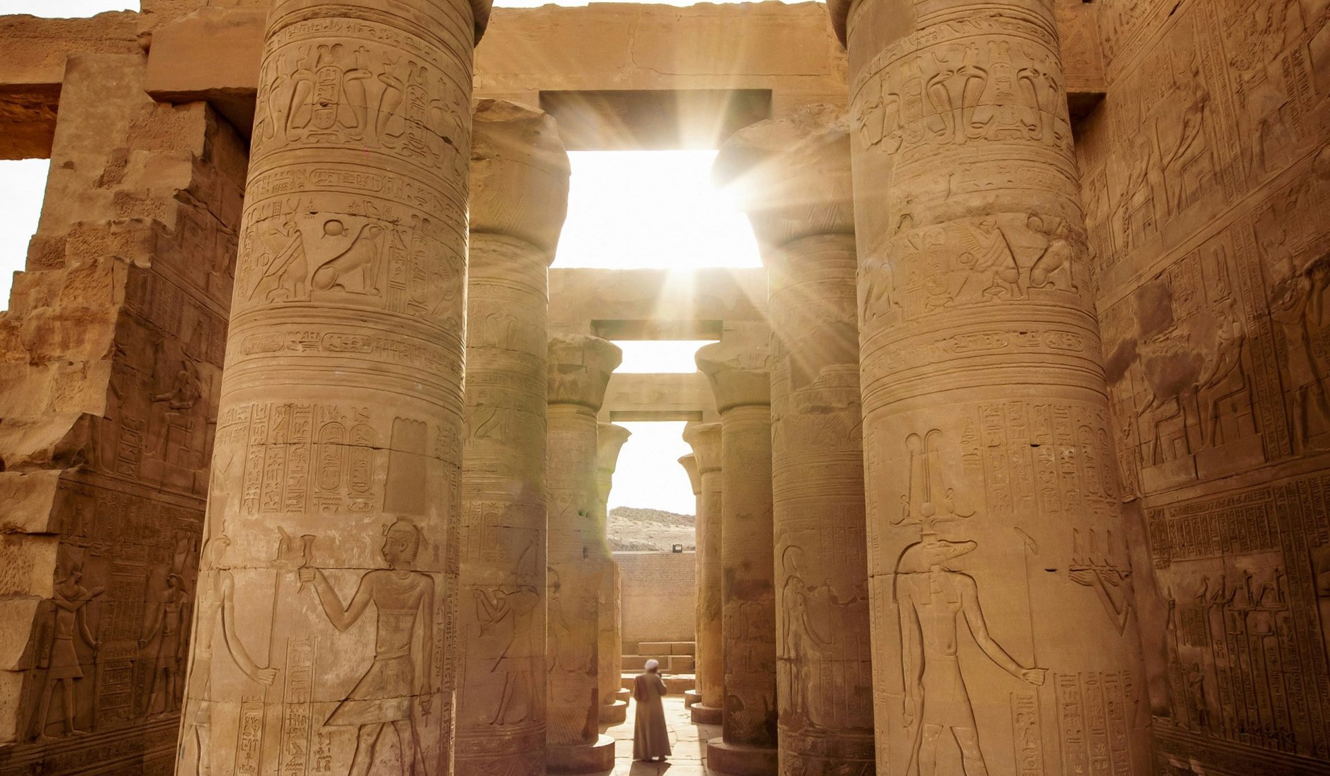 Sunlight between carved columns at an ancient Egyptian temple