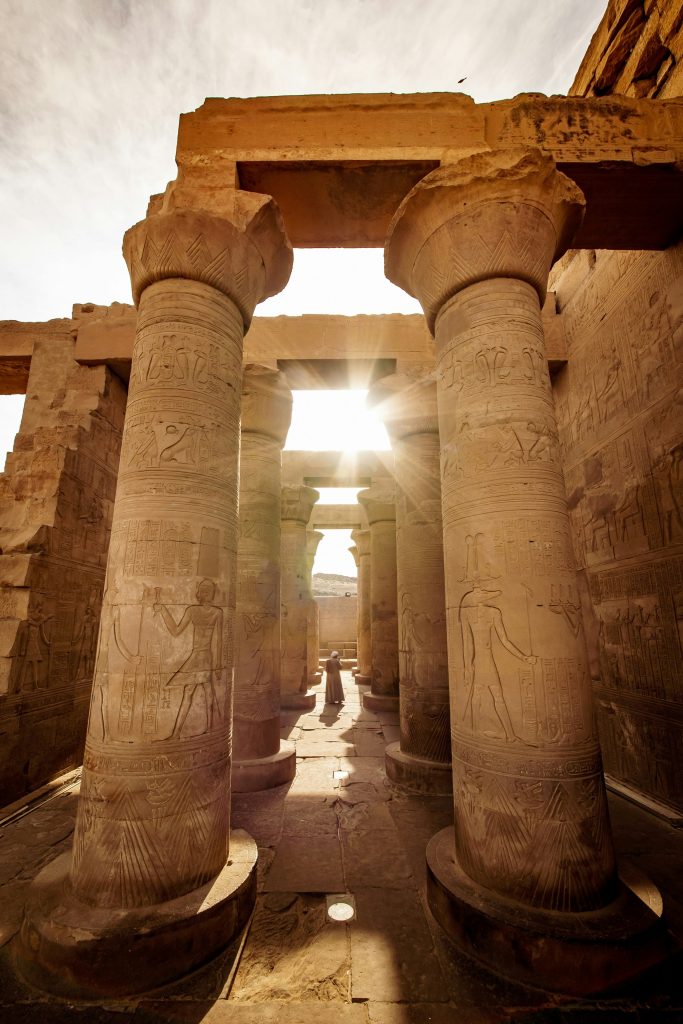 Sunlight between carved columns at an ancient Egyptian temple